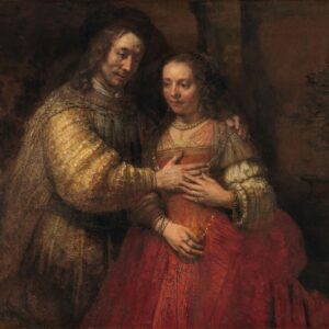 Het Joodse bruidje van Rembrandt: een man legt zijn hand op de borst van een vrouw in een rode jurk, hij in een goudgele mantel